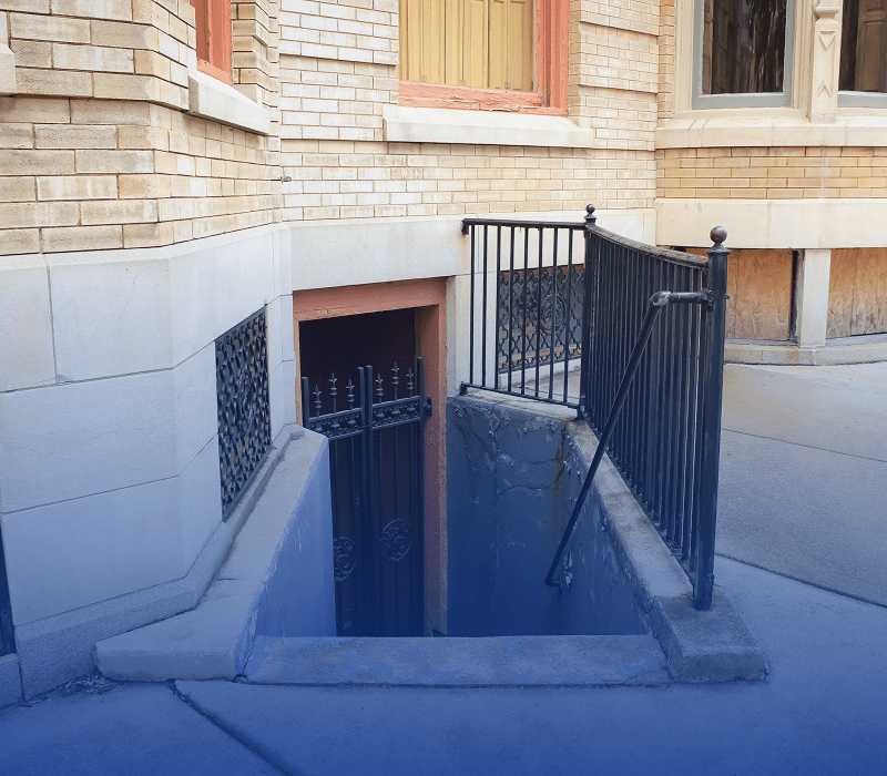 Staircase leading to basement door entrance.
