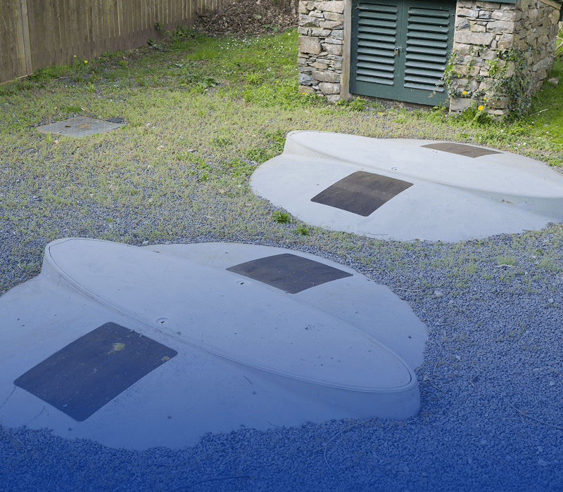 Concrete storm shelters in grassy area.